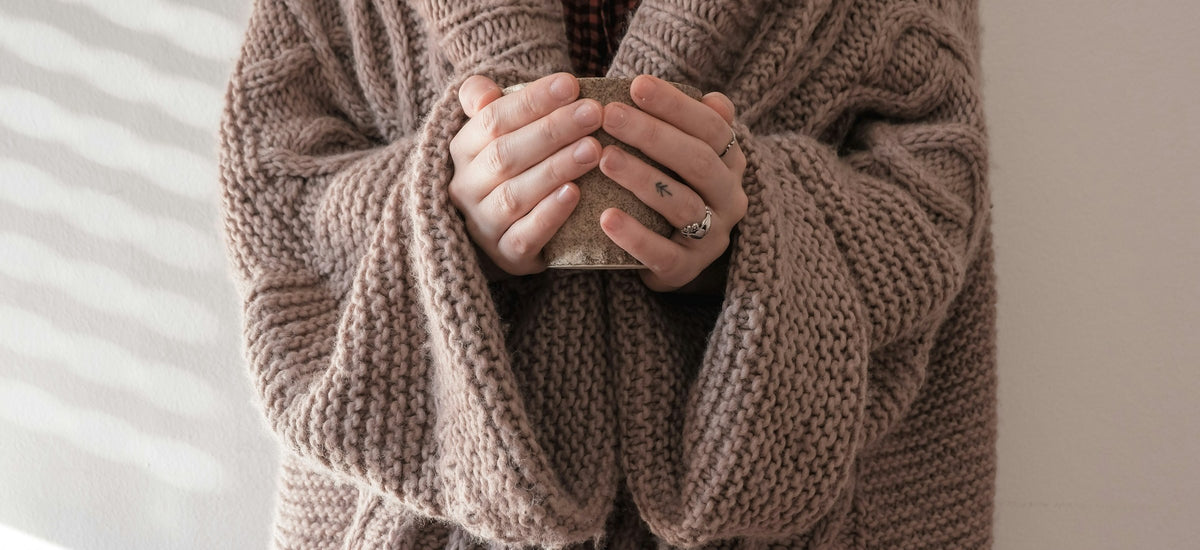 Cozy knit sweater and warm mug for fall